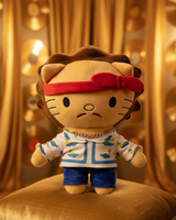 Bruno Mars Hello Kitty plush standing on a gold velvet chair in a warmly lit room.