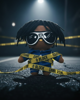 Chief Keef Hello Kitty plush in sunglasses and a blue outfit surrounded by yellow caution tape on a dark street.
