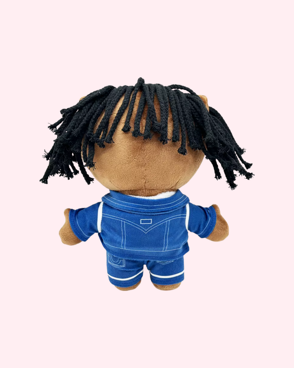 Back view of Chief Keef Hello Kitty plush showing black yarn hair and a blue denim-style outfit on a pale pink background.