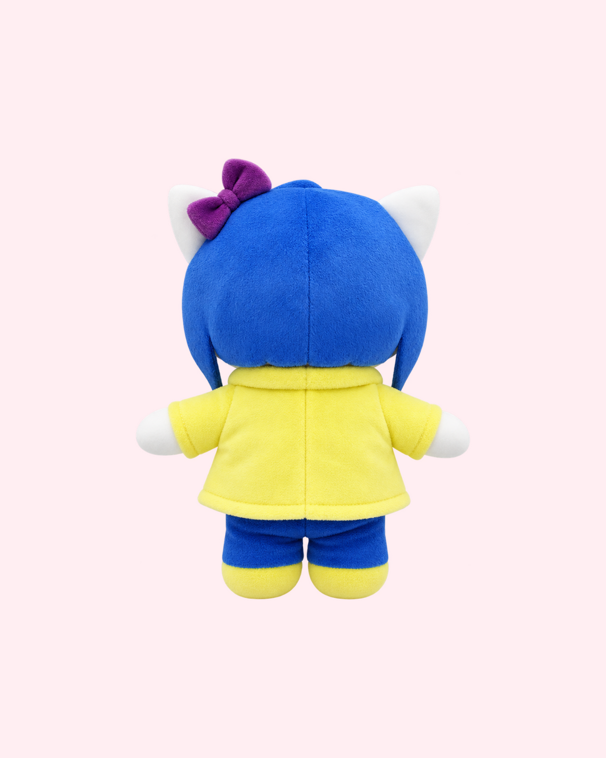 Back view of Coraline Hello Kitty plush with a blue bob haircut, a purple bow, a yellow raincoat and blue trousers, on a pale pink background.