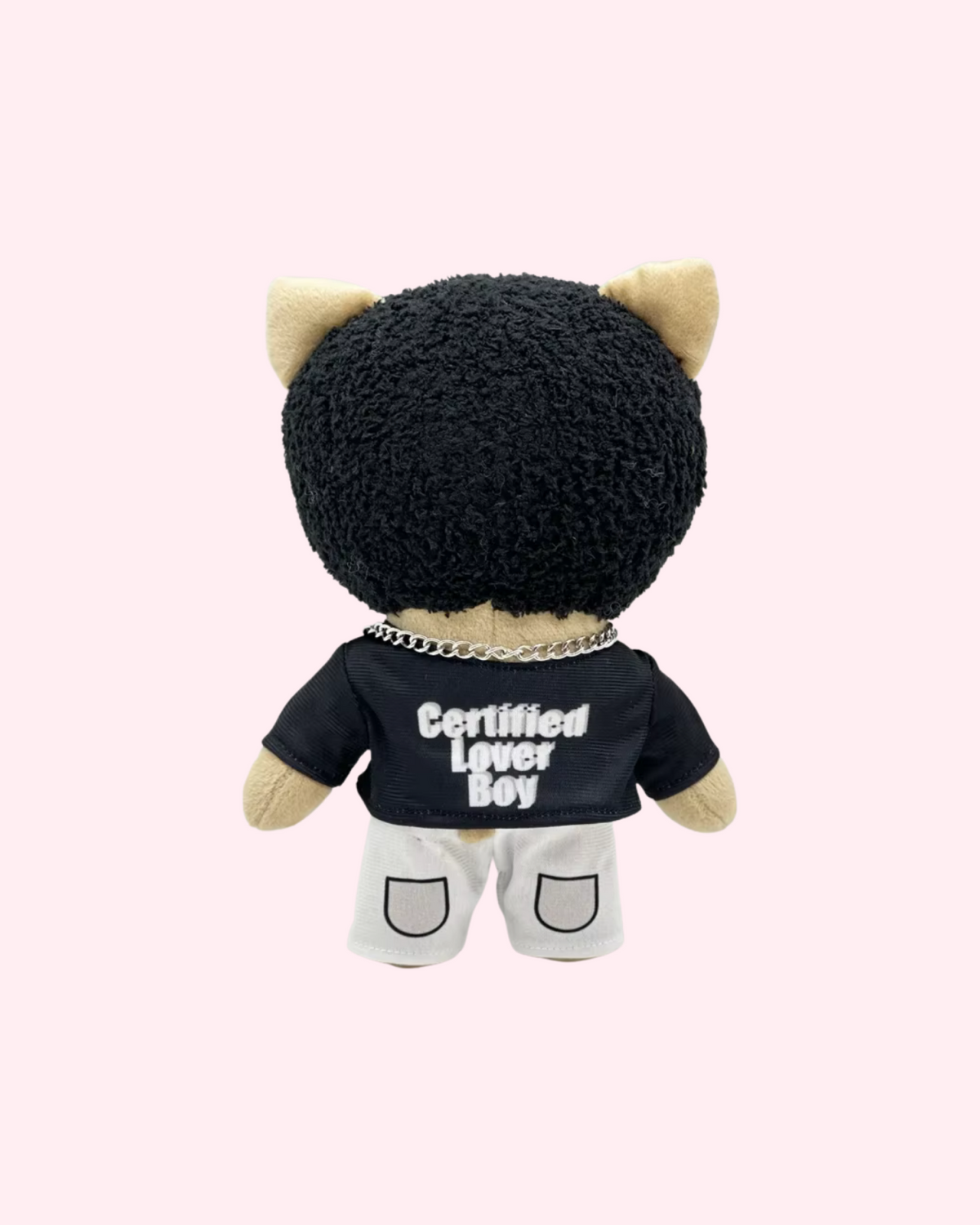 Back view of Drake Hello Kitty plush with short black hair and a black Certified Lover Boy shirt above white shorts, on a pale pink background.