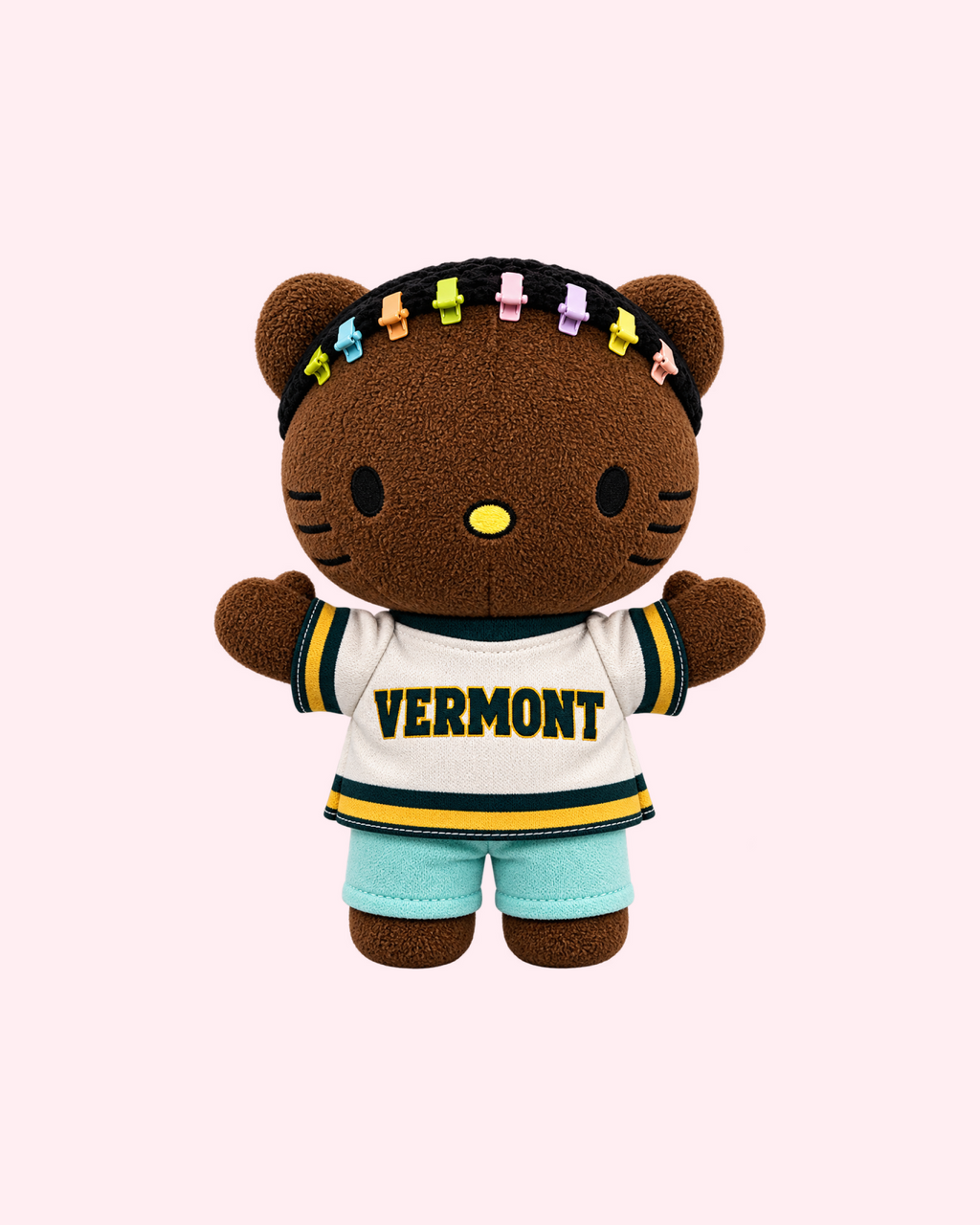 Front view of Drake Hello Kitty plush in a cream Vermont jersey and pale blue shorts with colourful hair clips on a pale pink background.