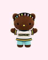 Front view of Drake Hello Kitty plush in a cream Vermont jersey and pale blue shorts with colourful hair clips on a pale pink background.