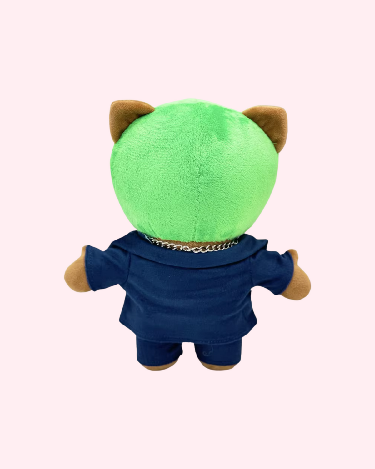 Back view of Frank Ocean Hello Kitty plush with bright green hair and a dark blue outfit, on a pale pink background.