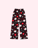Mirrored back view of black Hello Kitty pajama pants with red lipstick tubes, bows, hearts and gray eye-mask motifs
