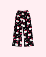 Front view of black Hello Kitty pajama pants with white character faces and pink bows