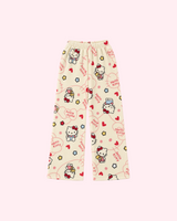 Front view of cream Hello Kitty pajama pants with red hearts, flowers and small bear motifs