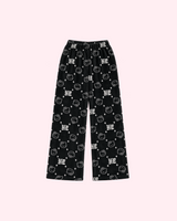Back view of black Hello Kitty pajama pants with white outlined faces, stars and HK lettering