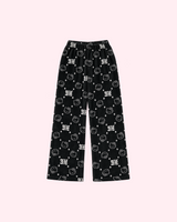 Front view of black Hello Kitty pajama pants with white outlined faces, stars and HK lettering