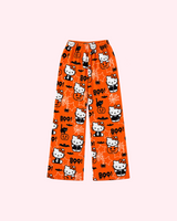 Front view of orange Hello Kitty Halloween pajama pants with pumpkins, bats and BOO lettering