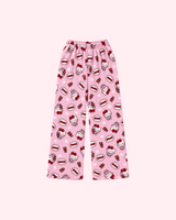 Front view of pale pink Hello Kitty pajama pants with teddy bears, red bows and small dots
