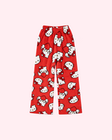 Front view of red Hello Kitty pajama pants with white character faces and winged hearts