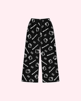 Front view of black pajama pants with white Hello Kitty outlines, bows and Hello Kitty lettering