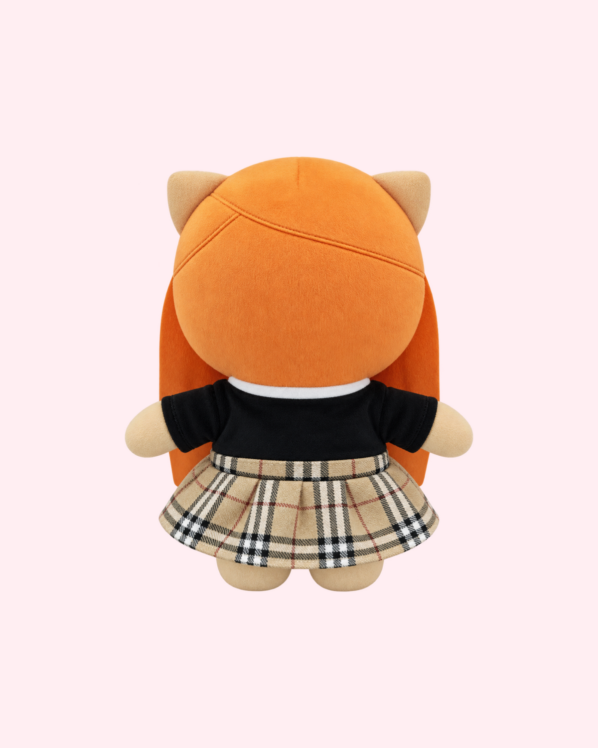Back view of Ice Spice Hello Kitty plush showing long orange hair, a black top and a beige plaid skirt on a pale pink background.