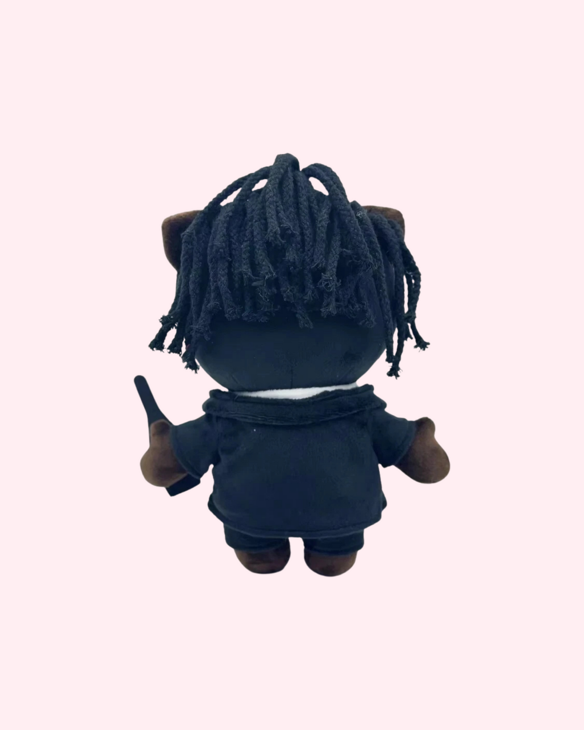 Back view of Jay-Z Hello Kitty plush showing black yarn hair and a dark jacket on a pale pink background.