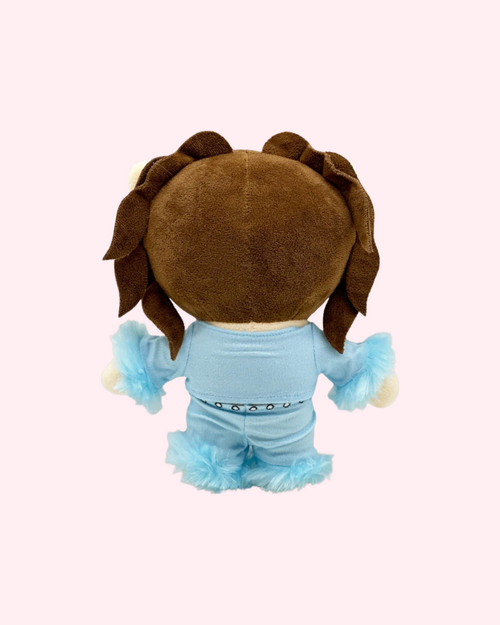 Back view of Kali Uchis Hello Kitty plush showing brown hair and a light blue outfit on a pale pink background.