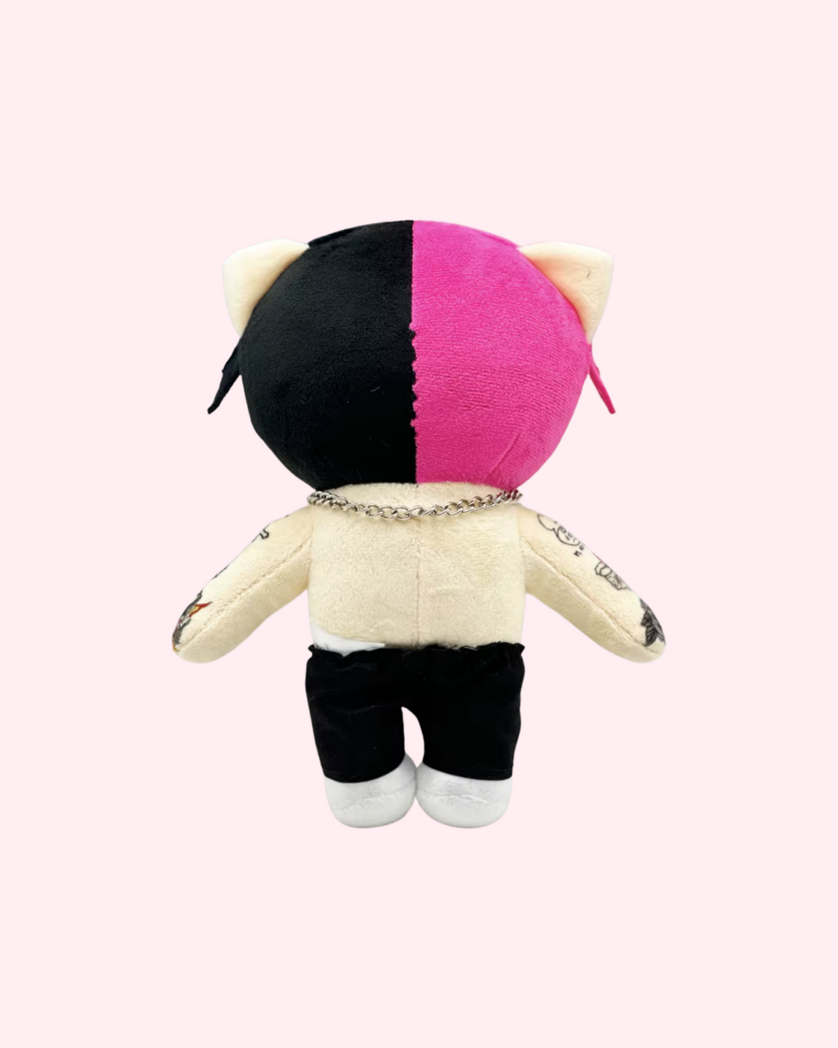 Back view of Lil Peep Hello Kitty plush with pink-and-black hair, a silver chain, a cream fabric torso and black trousers, on a pale pink background.