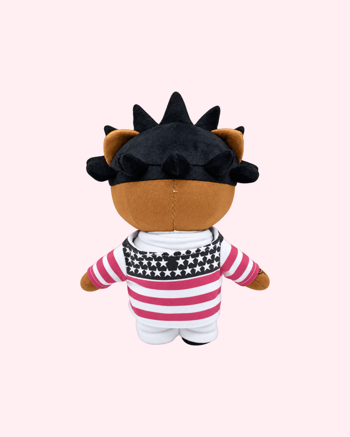Back view of Lil Uzi Vert Hello Kitty plush with black spiked hair, a pink-and-white stars-and-stripes jacket and white shorts, on a pale pink background.