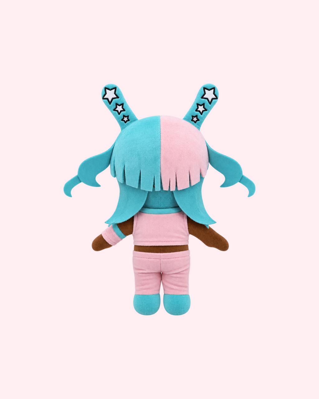 Back view of Megan Thee Stallion Hello Kitty plush showing cyan hair, pink clothing and cyan boots on a pale pink background.