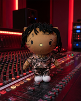NBA YoungBoy Hello Kitty plush in a camouflage outfit on a recording console under red studio lights.
