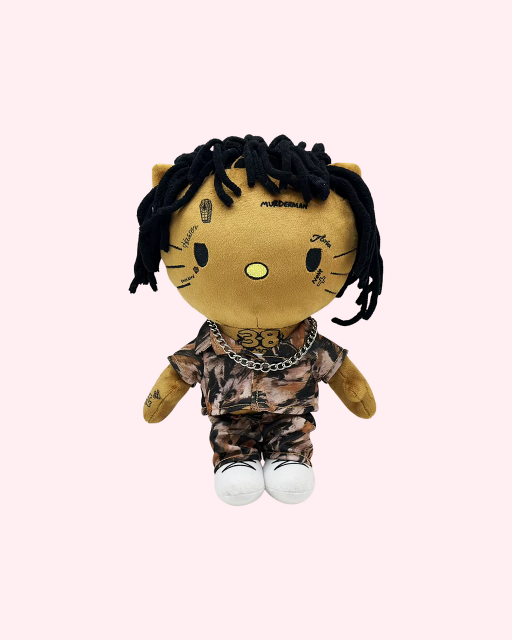 Front view of NBA YoungBoy Hello Kitty plush with black yarn hair, a camouflage outfit and white shoes on a pale pink background.