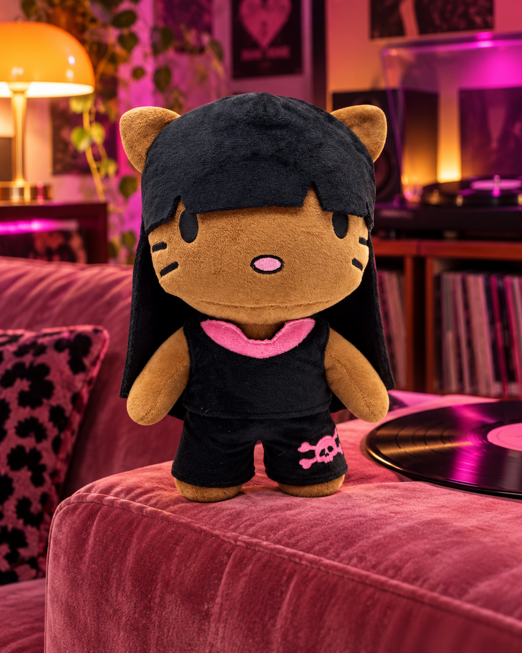 Nicki Minaj Hello Kitty plush in a black outfit on a pink velvet sofa arm beside a vinyl record.