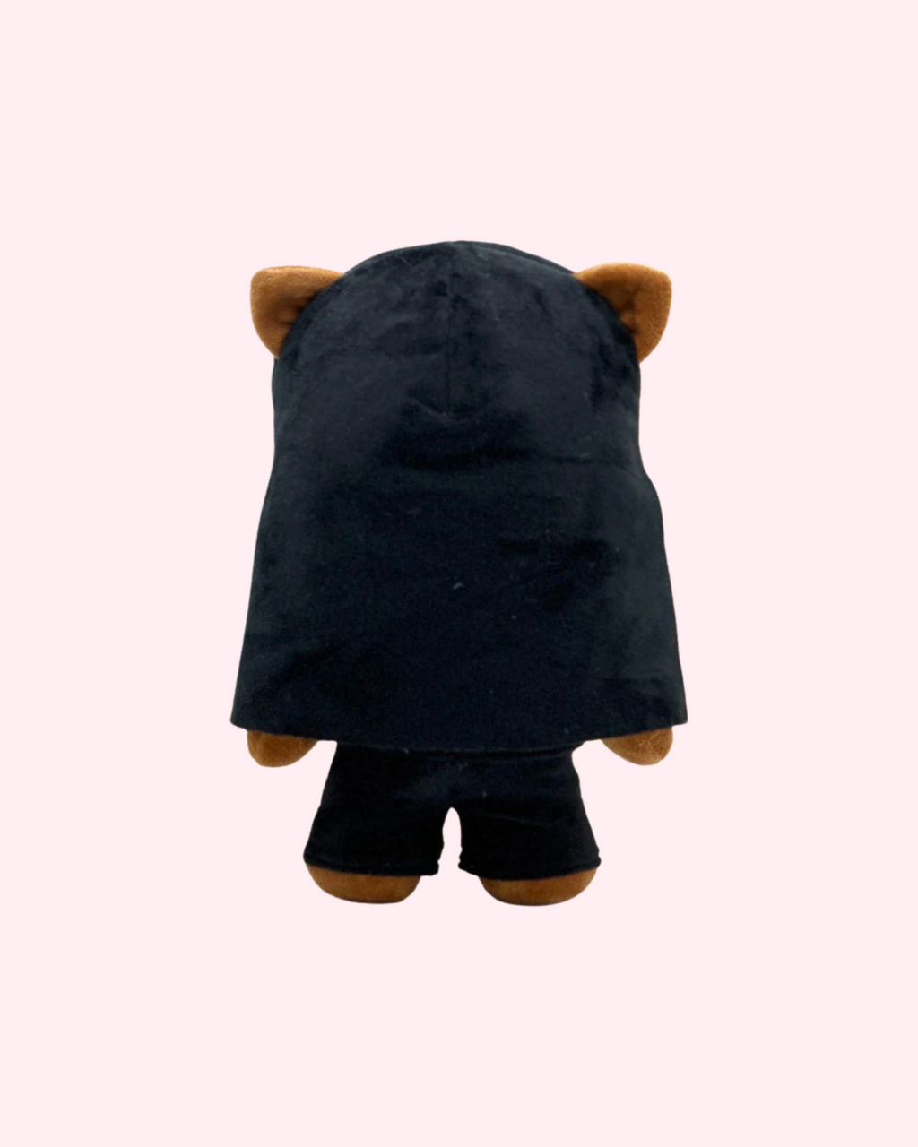 Back view of Nicki Minaj Hello Kitty plush showing long black hair and black shorts on a pale pink background.