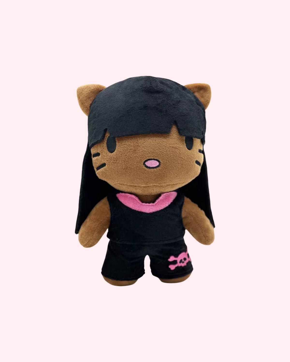 Front view of Nicki Minaj Hello Kitty plush with long black hair and a black outfit with pink details on a pale pink background.