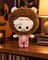 Post Malone Hello Kitty plush beside guitars and records in a warmly lit music room.