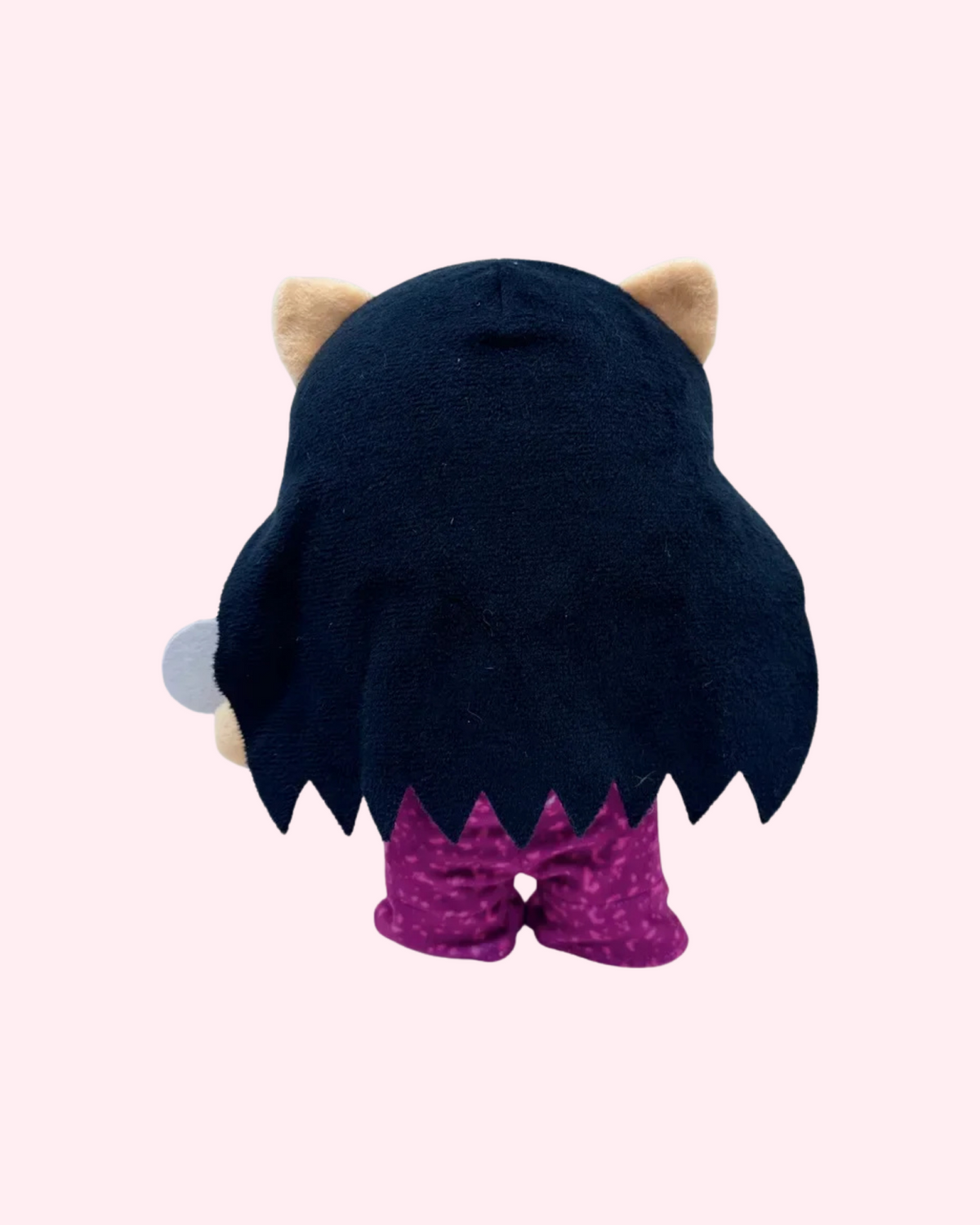 Back view of Selena Quintanilla Hello Kitty plush showing long dark hair and a purple outfit on a pale pink background.