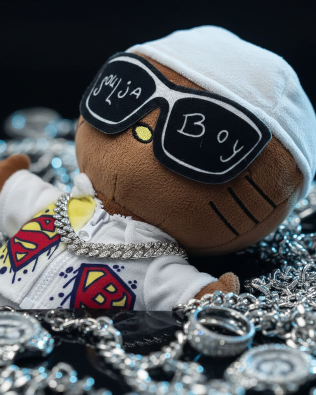 Close-up of Soulja Boy Hello Kitty plush wearing statement sunglasses and a silver-tone chain among jewellery.