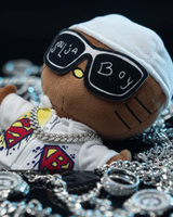 Close-up of Soulja Boy Hello Kitty plush wearing statement sunglasses and a silver-tone chain among jewellery.