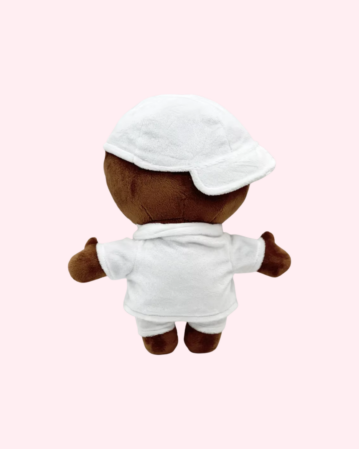 Back view of Soulja Boy Hello Kitty plush showing a white cap and white outfit on a pale pink background.